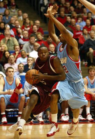 Ricky Harris drives on Marcus Johnson