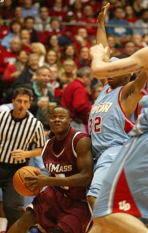 Ricky Harris drives on Marcus Johnson